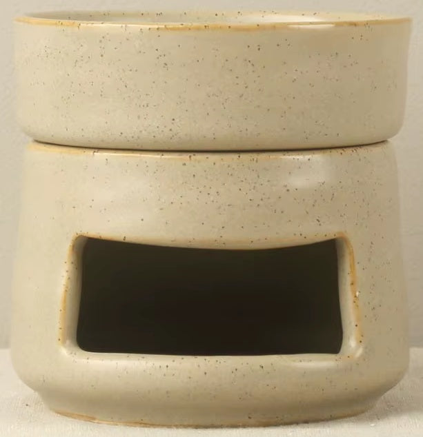 Speckled oatmeal ceramic oil warmer and wax melt burner with a rustic pottery look, matte finish, and tea light opening