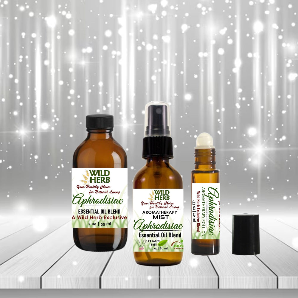 Three bottles of Wild Herb Aphrodisiac essential oil blend on a wooden surface with a sparkling background.