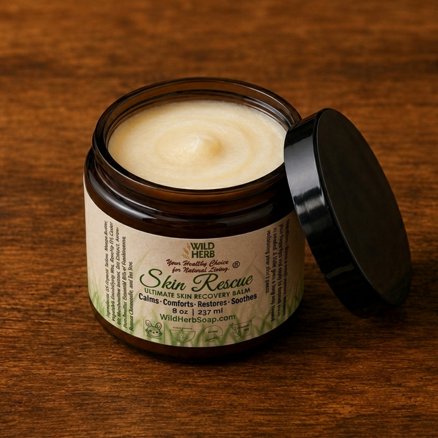 jar of Wild Herb Skin Rescue creamy balm in an amber colored jar with black lid