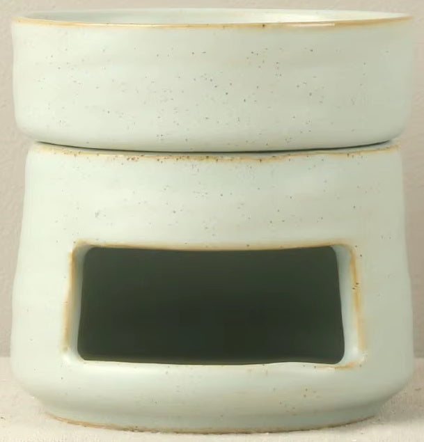 Speckled seafoam green ceramic oil warmer and wax melt burner with a vintage stoneware glaze and tea light cutout.