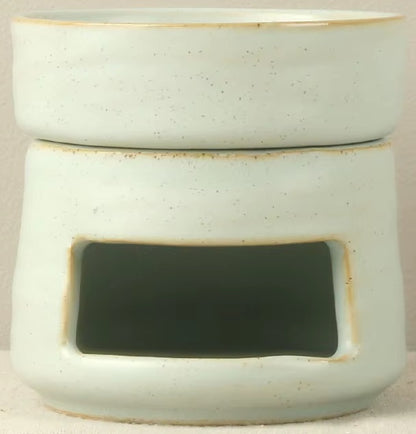 Speckled seafoam green ceramic oil warmer and wax melt burner with a vintage stoneware glaze and tea light cutout.