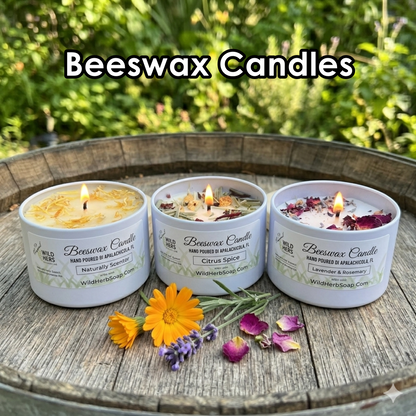 3 lit beeswax candles in white tins made by wild herb soap co